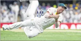  ??  ?? David Warner dives to catch the ball getting the wicket of Jake Ball.