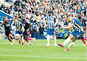  ??  ?? On the way: Neal Maupay puts Brighton ahead by scoring from the penalty spot yesterday
