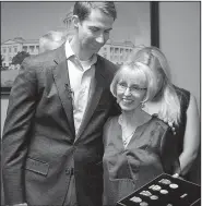  ?? Arkansas Democrat-Gazette/THOMAS METTHE ?? U.S. Sen. Tom Cotton hugs Charlotte Garlington after presenting her family with military medals for her father, George Anderson, at Cotton’s Little Rock office on Wednesday. Anderson, a WWII veteran, died in 2006.