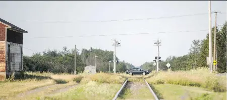  ?? DARIO AYALA ?? The railway crossing and wooden cross near Rivière-du-Loup, Que., where Laura Tardif, 18, was killed while texting and driving. It didn’t seem real at first, when police came to tell her, said her mother, Claudie Landry, above. “I could actually feel...