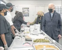  ?? SUSAN WALSH — THE ASSOCIATED PRESS ?? President Joe Biden and first lady Jill Biden arrive to assemble Thanksgivi­ng meal kits during a visit to DC Central Kitchen in Washington on Tuesday.