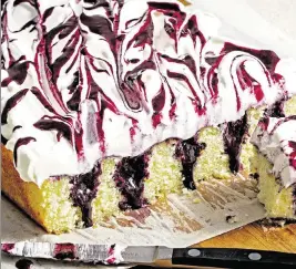  ?? SCOTT SUCHMAN For The Washington Post ?? To showcase the blueberry poke cake’s stripes in all their vibrant glory, slice the cake right through its rows of soak-filled holes when serving.