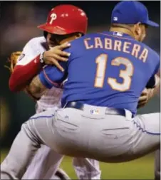  ?? LAURENCE KESTERSON — THE ASSOCIATED PRESS ?? The Phillies’ Nick Williams careens into third, safely landing in the arms of Mets third baseman Asdrubal Cabrera after a sacrifice fly by Odubel Herrera in the third inning Friday night at Citizens Bank Park.