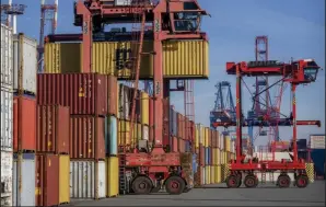  ?? (AP/Michael Probst) ?? Cranes move containers at the harbor in Hamburg, Germany, last week.