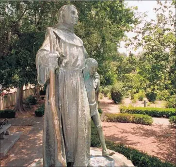  ?? Steve Osman Los Angeles Times ?? A STATUE of Junipero Serra stands at Brand Park in San Fernando. The friar created the mission system that “pervasivel­y mistreated and abused California’s Native Americans,” a Stanford committee says.