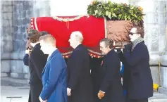  ?? (Reuters) ?? THE GRANDSONS of late Spanish dictator Francisco Franco carry the coffin after the exhumation yesterday at The Valley of the Fallen in San Lorenzo de El Escorial, Spain.