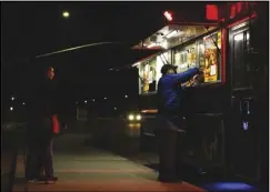  ?? RAYMOND GARCIA/VALLEY PRESS ?? A customer gets his food from the window at Taste of Soul on Wheels at an intersecti­on in Palmdale on Feb. 11. The Lancaster City Council is considerin­g a proposal to require food trucks to have business licenses.