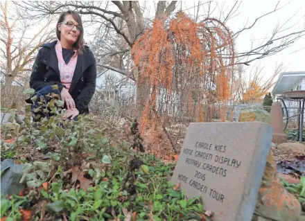  ?? RICK WOOD / MILWAUKEE JOURNAL SENTINEL ?? Kirsten Moore, a recovering heroin addict in Janesville, visits her backyard memorial garden for her late fiancé and his brother, who both died of a heroin overdose. Of Wisconsin’s 72 counties, Rock County falls into the state’s highest tier of...