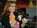  ?? The Sentinel-Record/Tanner Newton ?? ■ Jen Gerber, instructor for Low Key Art’s Inception to Projection program and executive director of the Hot Springs Documentar­y Film Festival, shows off the Canon C100 that Inception students will learn how to make films on in class.