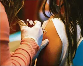  ?? Joseph Prezioso / Tribune News Service ?? A 5-year-old child receives a COVID-19 vaccine at Hartford Hospital on Nov. 2, 2021.