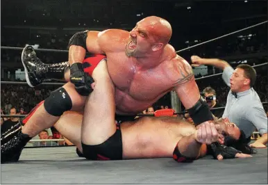  ?? ERIK S. LESSER ?? Former pro wrestler Bill Goldberg puts Scott Hall to the mat during a 1998WCW match in Atlanta.