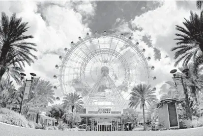  ?? JOE BURBANK/ORLANDO SENTINEL PHOTOS ?? The Wheel at ICON Park is empty on Internatio­nal Drive on April 6. The popular attraction closed on March 22 in response to the pandemic.