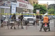  ?? AHMED YEMPABOU OUOBA / ASSOCIATED PRESS ?? Security forces stand guard Monday outside an upscale Turkish restaurant in Ouagadougo­u, the capital city of Burkina Faso. Two rifle-wielding men attacked the restaurant Sunday.