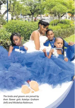  ??  ?? The bride and groom are joined by their flower girls Katelya Graham (left) and Mickelsia Robinson.