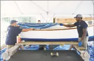  ?? Tyler Sizemore / Hearst Connecticu­t Media ?? Program instructor Josh Mayo, left, and recent high school graduate Jeremiah Davis work to restore a boat at the SoundWater­s Harbor Corps marine job training program at John J. Boccuzzi Park in Stamford on Thursday.