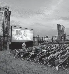  ?? Courtesy Rooftop Cinema USA ?? Moviegoers watch a film at Rooftop Cinema Club in San Diego. The Houston location will be at BLVD Place in the Galleria area.