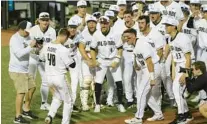  ?? JASON BEEDE/ORLANDO SENTINEL ?? UCF’s baseball team greets Ben McCabe (40) at home plate after the Knights catcher hit a 2-run shot in the third inning vs. Siena on Friday night at John Euliano Park.