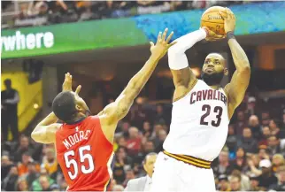  ??  ?? CLEVELAND CAVALIERS forward LeBron James (23) shoots over the defense of New Orleans Pelicans guard E’Twaun Moore (55) during the second half at Quicken Loans Arena.