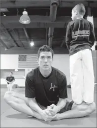  ??  ?? All in family, Part I: Lopez gets help stretching from his nephew Diego at the Lopez Taekwondo Academy in Sugar Land.