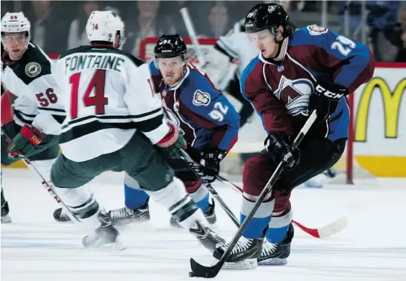  ?? Doug Pensinger /Gett y Images/File ?? Colorado’s Nathan MacKinnon, right, controls the puck as teammate Gabriel Landeskog fends off Minnesota’s Justin Fontaine during Game 5 of their series.