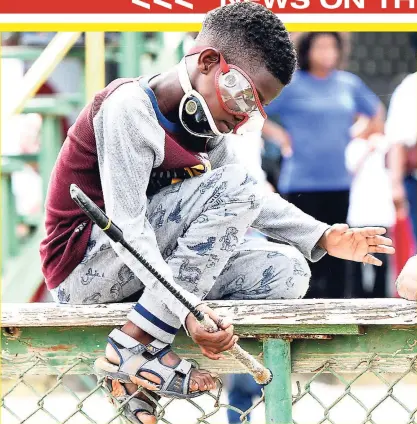  ?? IAN ALLEN ?? This youngster pretends to be a jockey while straddling the fence at Caymanas Park, St Catherine, on Cal’s Race Day recently.