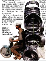  ??  ?? Bike of burden: Moving a heavy load