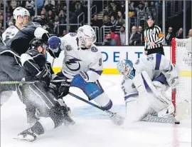  ?? Harry How Getty Images ?? TAMPA BAY goalie Peter Budaj makes a save on a shot by the Kings’ Jake Muzzin. Budaj had 22 saves as the Lightning won the battle of division leaders.