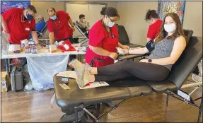  ?? (Special to NWA Democrat-Gazette/Rick Harvey) ?? Courtney Jones, head lifeguard at the Property Owners Associatio­n’s Kingsdale Pool, gives blood last week during an American Red Cross blood drive held at Lakepoint Restaurant. The event was the first for the associatio­n’s “Giving Back” campaign.