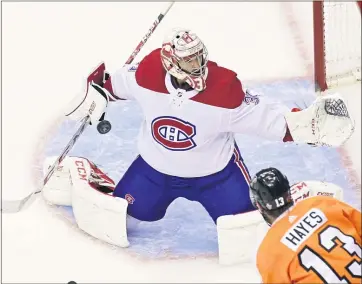  ?? FRANK GUNN — THE CANADIAN PRESS VIA AP ?? Montreal Canadiens goaltender Carey Price (31) makes a save as Philadelph­ia Flyers center Kevin Hayes (13) looks on during Friday’s Eastern Conference playoff game in Toronto.
