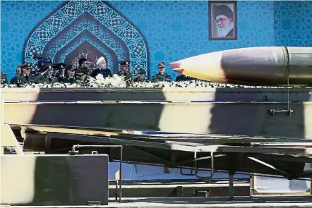  ??  ?? Show of force: Rouhani (in white turban) attending an armed forces parade in Teheran. — Reuters