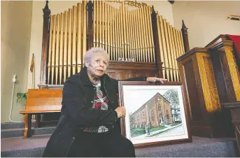  ?? NICK BRANCACCIO ?? Nancy Allen, clerk of the British Methodist Episcopal Church Ontario Chapel on University Avenue East, holds up an image of the church that dates back to 1856.