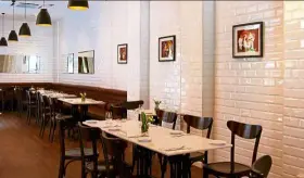  ??  ?? The interior of Two Ox is widely spaced and features elegant marble top tables and Italian-tiled walls.