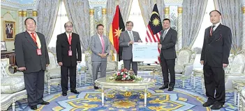  ??  ?? Abang Johari (fourth left) presenting the cheque to Wee (second left) while Dr Sim (third left) and other committee members look on.