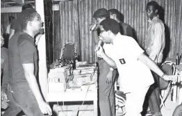  ?? GLEANER PHOTO ?? Winston Blake (with mic) of the Merritone Discothequ­e is caught in a celebrator­y mood at Club Sombero at a Sunday session in 1967. Beside him is brother Trevor (having a drink) with fans looking on.