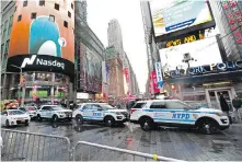  ?? AP ?? Police cars are parked along a street in New York’s Times Square. After two recent deadly attacks in the city, officials have organized a bigger security detail than usual at Sunday’s New Year’s Eve celebratio­n in Times Square.
