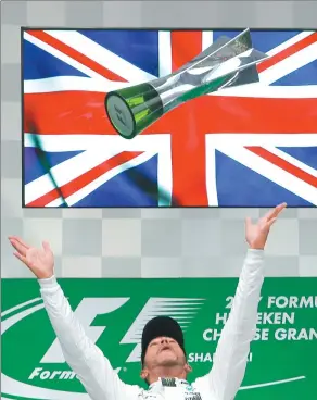 ?? TORU TAKAHASHI / AP ?? Mercedes driver Lewis Hamilton of Britain tosses his trophy into the air after winning the Chinese Formula One Grand Prix at the Shanghai Internatio­nal Circuit on Sunday.