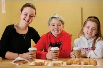  ??  ?? From left, Holly, Daniel and Alexa serve up chocolat chaud, croissants, and crêpes to their school community.