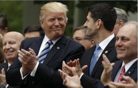  ?? EVAN VUCCI — THE ASSOCIATED PRESS ?? President Donald Trump talks with House Speaker Paul Ryan of Wis., in the Rose Garden of the White House in Washington, Thursday after the House pushed through a health care bill. House Majority Whip Steve Scalise of La. is at left, and House Ways and...