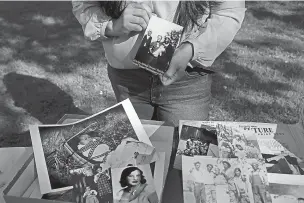  ?? RACHEL BUJALSKI/WASHINGTON POST ?? Quirina Geary shows family photograph­s. As a member of the Mutsun tribe in Central California, reviving the tribe’s language is a matter of reclaiming a part of her identity.