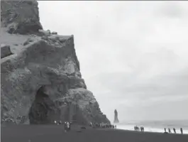  ?? PHOTOS BY JESSICA KWONG, TNS ?? The crashing waves at Black Sand Beach appear snow white against the dark pebble sand and cliffs of basalt columns towering overhead.