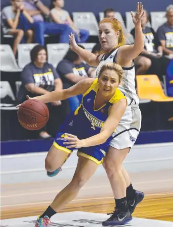  ?? EVASIVE MOVE: Townsville Flames’ Abby Bishop steps past the defence of Rockhampto­n Cyclones’ Briana Bailey during their clash on Saturday night. Picture: WESLEY MONTS ??