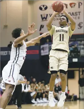  ?? JANE TYSKA — BAY AREA NEWS GROUP ?? Salesian’s James Akinjo (11) shoots over Modesto Christian’s Junior Ballard. The Pride won the MLK Classic game, but Akinjo wasn’t satisfied with the team’s performanc­e.