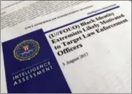  ?? JON ELSWICK - THE ASSOCIATED PRESS ?? In this Nov. 17, 2017, photo, the cover page of a FBI report on the rise of black “extremists” is photograph­ed in Washington. The report is stirring fears of a return to practices of the Civil Rights era, when the agency notoriousl­y spied on activist...