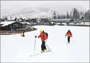  ??  ?? Skiers ski up an empty run at a Vail Resorts Inc. location in Vail, Colo., in March of 2020. (Bloomberg/Michael Ciaglo)