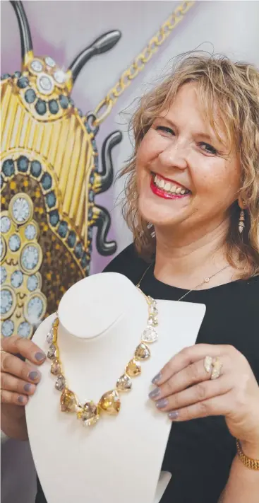  ?? Picture: BRENDAN RADKE ?? SPARKLING: Swarovski store manager Lida Fitzgerald showcases some of the jewellery that will be on sale when the new store opens next Thursday.