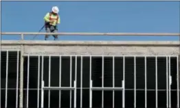  ?? MARK HUMPHREY — THE ASSOCIATED PRESS FILE ?? Workers build an apartment and retail complex in Nashville, Tenn. The U.S. economy slowed to a moderate 2.3 percent annual growth rate in the first quarter as consumer spending turned in the weakest performanc­e in nearly five years.