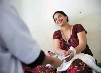  ??  ?? Nepali mother Pabitra Dhungel benefits from the “protection for mothers,” a program which has helped over 2 million women access medical services in the impoverish­ed country. — AFP