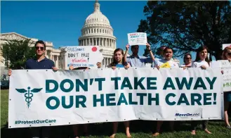  ??  ?? Protests over the Republican­s healthcare bill outside the US Capitol in Washington DC