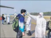  ??  ?? Medics screen Indian nationals after they were brought by an Air India aircraft from China's coronaviru­s-hit city of Wuhan, at the New Delhi airport on February 20.
PTI