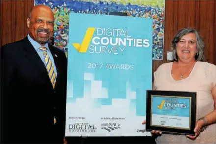  ?? SUBMITTED PHOTO ?? Chester County Commission­ers Terence Farrell and Kathi Cozzone accept the National Digital Counties Survey award at the National Associatio­n of Counties Conference in Columbus, Ohio.